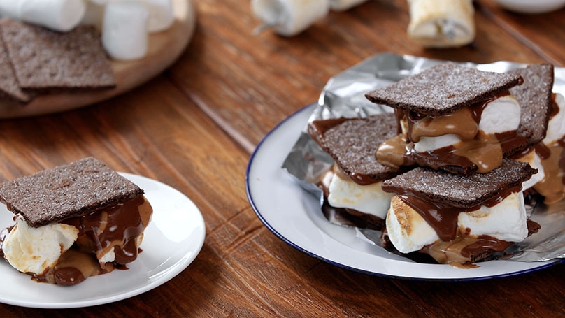 Peanut Butter Dip S'mores on plates, wood table