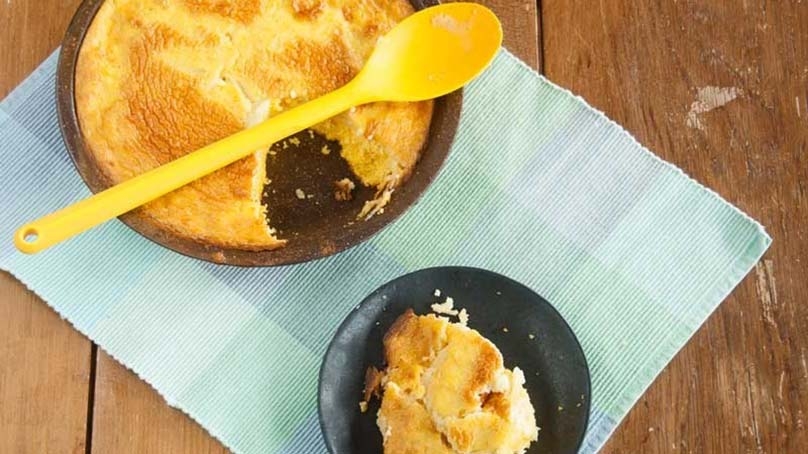 Spoon Bread, baking dish, serving on plate, woodenn spoon, placemat, wood table