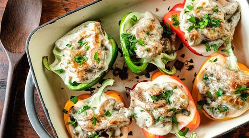 Cheesesteak Stuffed Peppers, baking dish wood table  serving spoon