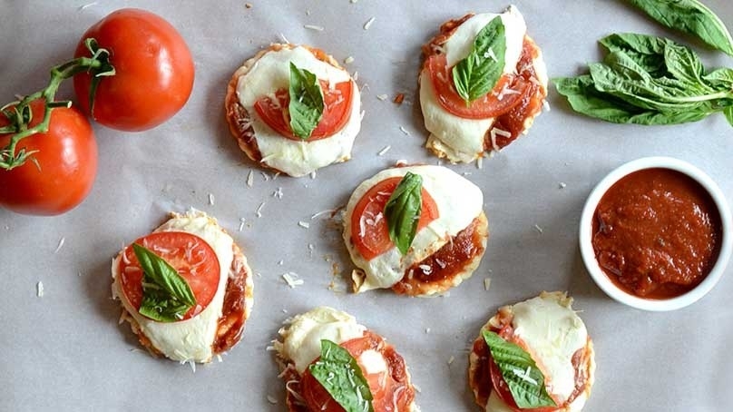 Mini Margherita Pizzas, tomatoes, cruet of tomatoe sauce, basil