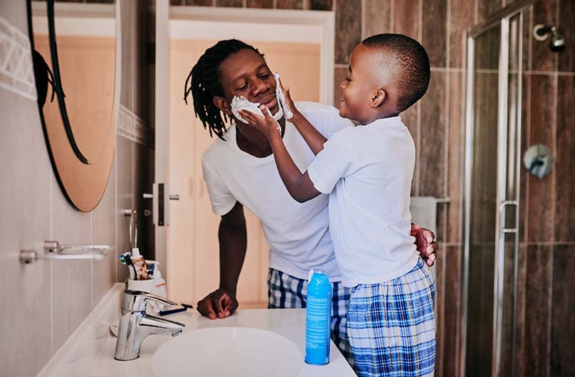 Father and son with shaving cream