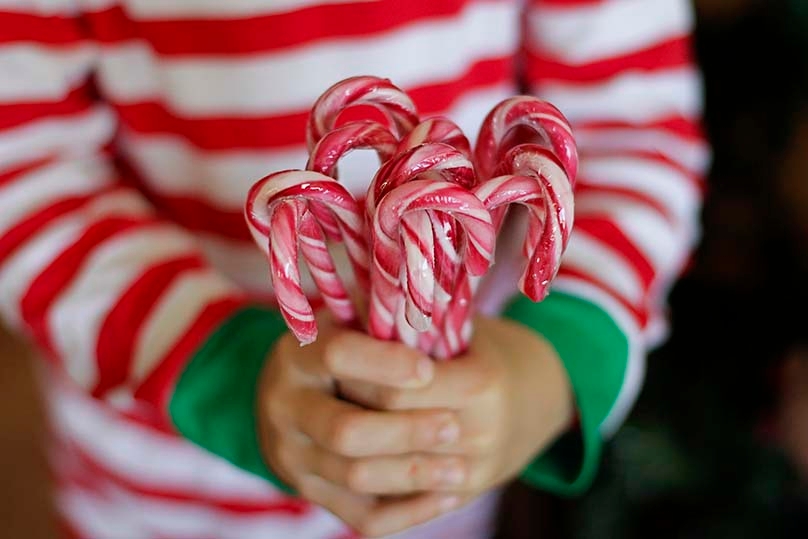 Child holding candy canes