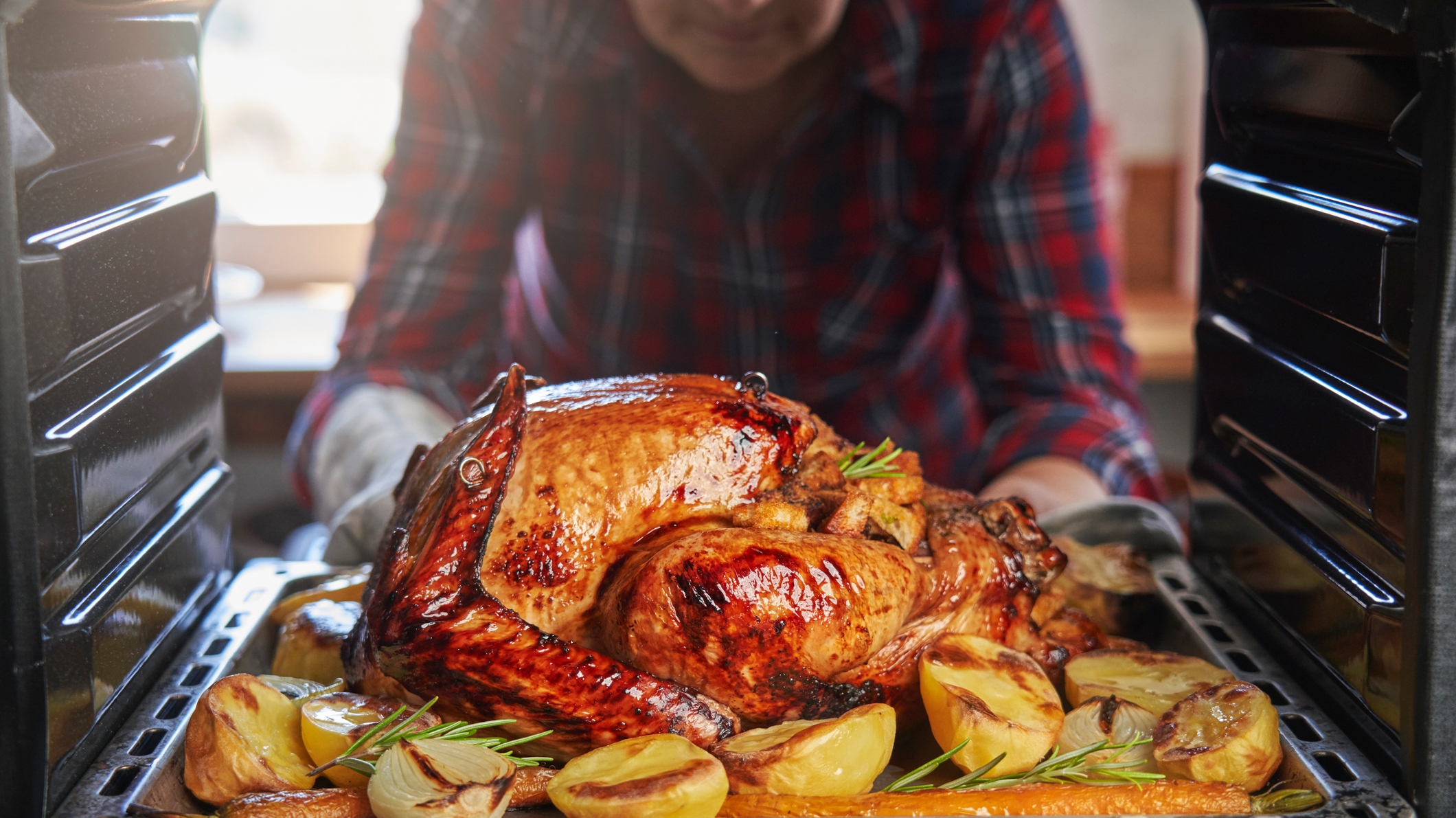 Thanksgiving turkey being removed from oven