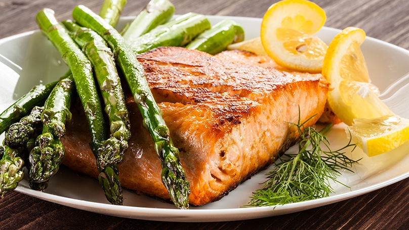 Salmon in the shape of a heart, on top of salad