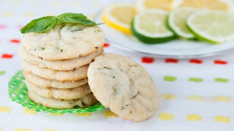 Lemon-Lime Basil Shortbread Cookies, plate of lime and lemon slices, ploka dot table cloth