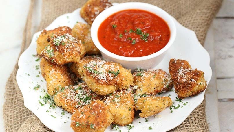 Parmesan Chicken Bites, bowl of marinar dipping sauce, white china, textured cloth, rustic wood table