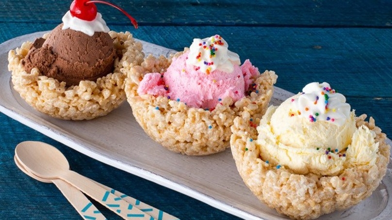 Rice Krispie Bowls, spoons, sprinkles, whippes cream